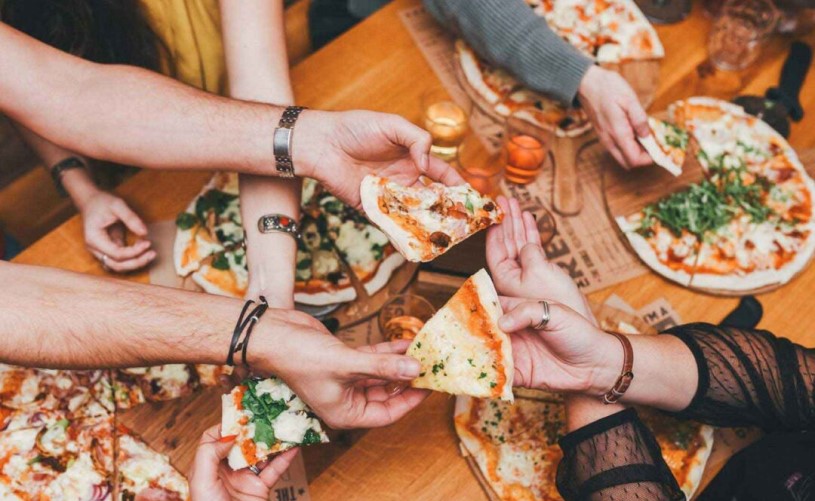 The Stable people sharing pizza
